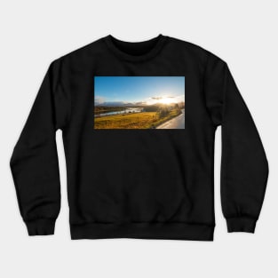 Beautiful norwegian scenery. Mountains in background. Horses are on the farm near river Crewneck Sweatshirt